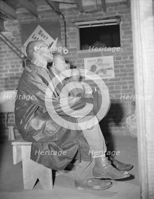 Air raid wardens attending a meeting in their headquarters, Washington, D.C., 1943. Creator: Gordon Parks.