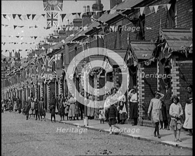 People Out the Front of Their Houses in a Street Decorated With Union Flag Bunting in Belfast, 1921. Creator: British Pathe Ltd.