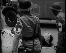 Four Chinese Red Cross Society of China Staff Carrying a Stretcher Supporting an Injured..., 1938. Creator: British Pathe Ltd.