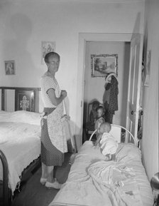 Grandchild of Mrs. Ella Watson, a government charwoman, taking her...nap, Washington, D.C, 1942. Creator: Gordon Parks.