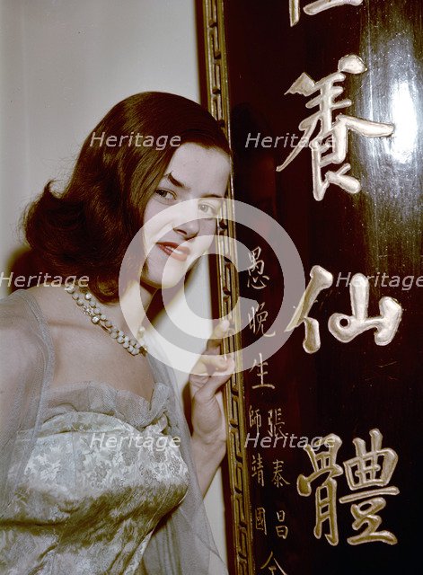 Model showing an evening dress in oriental style, 1950s.  Artist: Göran Algård