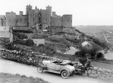 A Singer car in front of Harlech Castle, Wales, early 1920s. Artist: Unknown