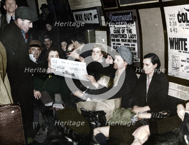 Paper seller down in the underground, London, c.1940. Artist: Unknown.