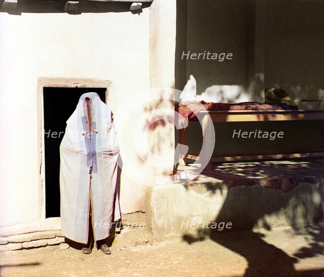 Woman in purdah, standing in front of doowrway, between 1905 and 1915. Creator: Sergey Mikhaylovich Prokudin-Gorsky.
