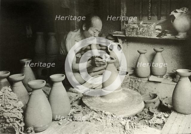 'The Potter at his Wheel', 1910. Creator: Herbert Ponting.