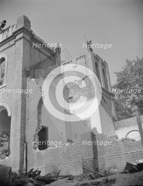 Laborers wrecking buildings on Independence Avenue, Washington, D.C, 1942. Creator: Gordon Parks.