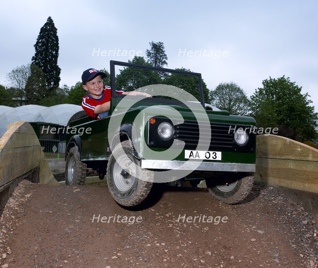 Child driving a toy Land Rover. Artist: Unknown.