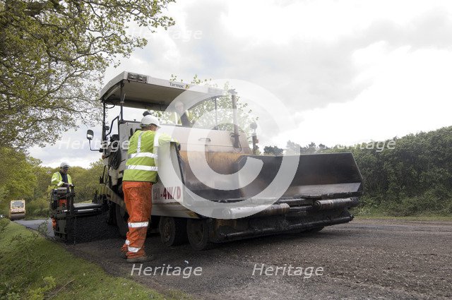 Road resurfacing work repairing potholes Artist: Unknown.