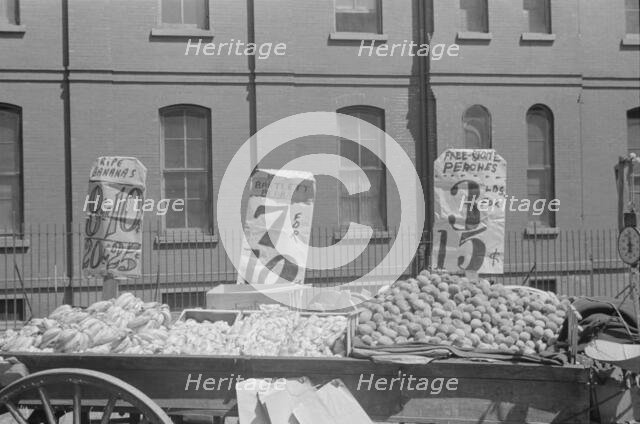 A fruit and vegetable vendor stand, 61st Street between 1st and 3rd Avenues, New York, 1938. Creator: Walker Evans.