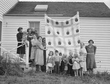 Farm women of the "Helping Hand" club display a pieced quilt..., near West Carlton, Oregon, 1939. Creator: Dorothea Lange.