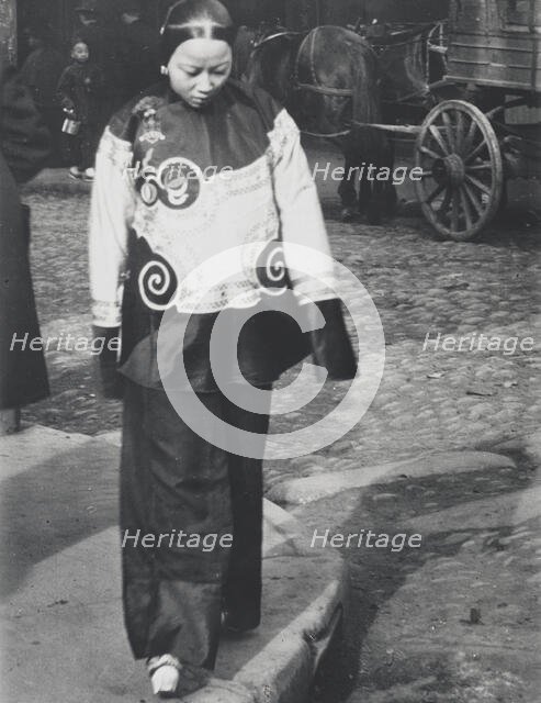 A woman in holiday attire, Chinatown, San Francisco, between 1896 and 1906. Creator: Arnold Genthe.