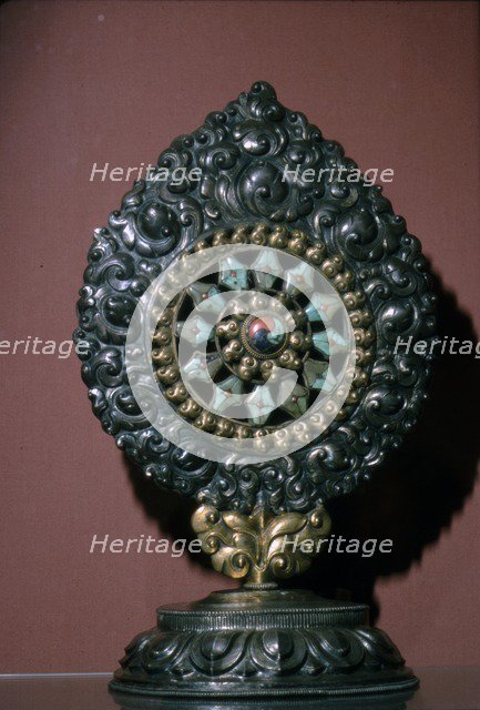 Tibetan Wheel of the Law inlaid with turquoise and coral. Artist: Unknown.