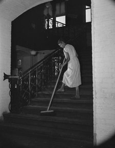 Government charwoman cleaning after regular working hours, Washington, D.C., 1942. Creator: Gordon Parks.