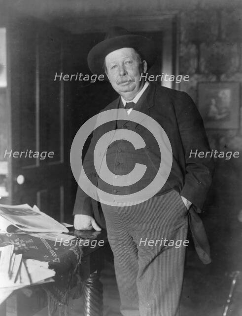 Joel Chandler Harris, three-quarter-length portrait, standing, facing slightly left, c1890 and 1910. Creator: Frances Benjamin Johnston.