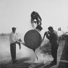 Workers wrapping and sealing the end of a steel pipe on the Fens gas pipeline, Norfolk, 24/07/1967. Creator: John Laing plc.