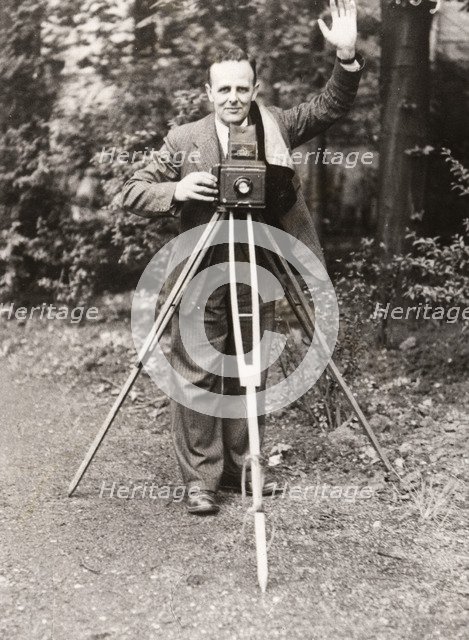 A photographer stands with his camera, County Industries, York, Yorkshire, 1943. Artist: Unknown