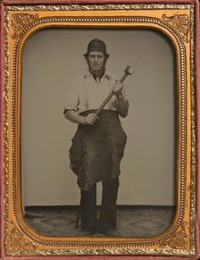 Man Gripping Sledgehammer, Wearing Leather Half Apron and Cap, 1850s-60s. Creator: Unknown.