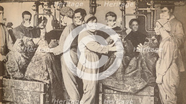 'Munition Workers Wearing Respirators While Filling Sells with Trinitrotoluene (T.N.T.)', c1916, (19 Artist: Unknown.