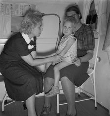 In trailer clinic, the nurse consults the migrant..., Merrill FSA camp, Klamath County, Oregon, 1939 Creator: Dorothea Lange.