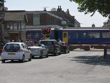 Train passing through level crossing in Lincoln 2014 Artist: Unknown.