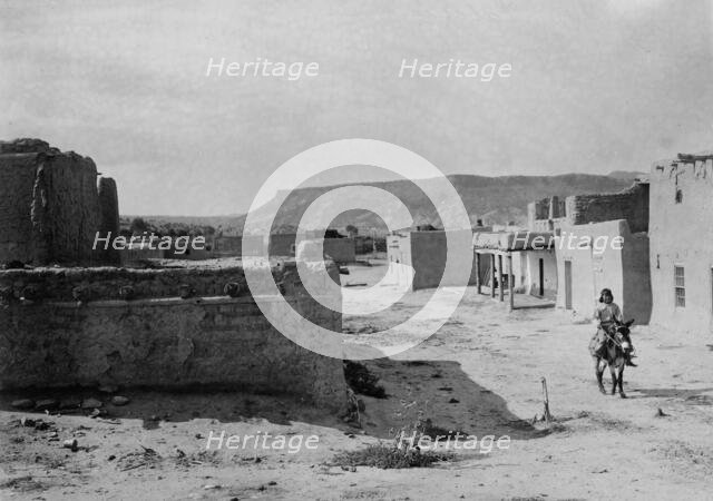 A street scene in San Ildefonso Pueblo, 1905, c1905. Creator: Edward Sheriff Curtis.