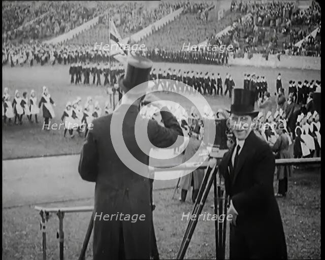 Male Newsreel Camera Operators Carrying Tripods and Equipment, 1920s. Creator: British Pathe Ltd.