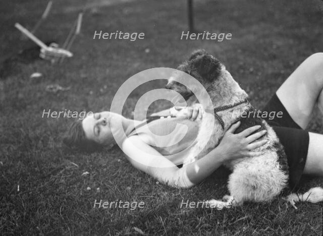 McKeogh, Arthur, Mrs., with dog, outdoors, 1927 Creator: Arnold Genthe.