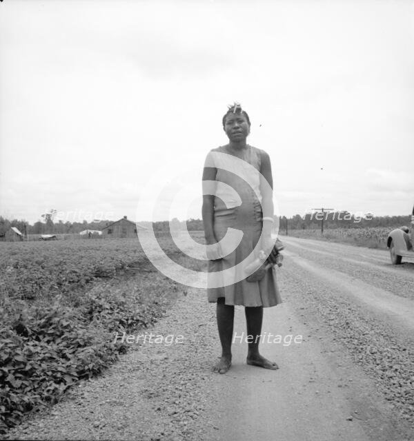 Negro woman carrying her shoes home from church, Mississippi Delta, 1936. Creator: Dorothea Lange.