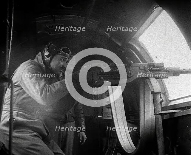 Actor Clark Gable Firing a Machine Gun Out of a Warplane, 1943-1944. Creator: British Pathe Ltd.