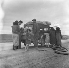 Migrants, family of Mexicans, on road with tire trouble, looking for work...California, 1936. Creator: Dorothea Lange.