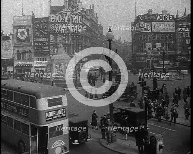 People and Traffic Moving Through Piccadilly Circus in London, 1940.  Creator: British Pathe Ltd.