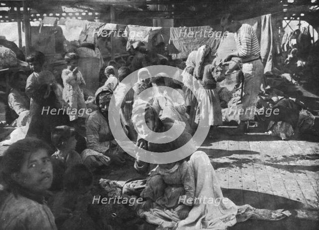 'L'aide Francaise aux Armeniens; Campes sur le pont du croiseur ou'ils avaient..., 1915 (1924). Creator: Unknown.