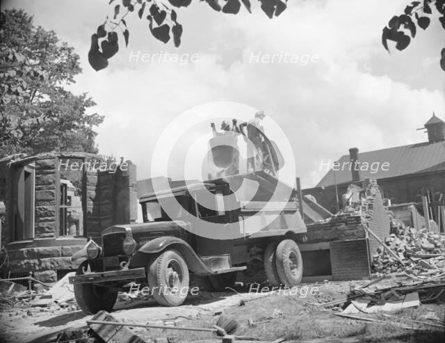 Loading debris from wrecked buildings along Independence Avenue, Washington, D.C, 1942. Creator: Gordon Parks.