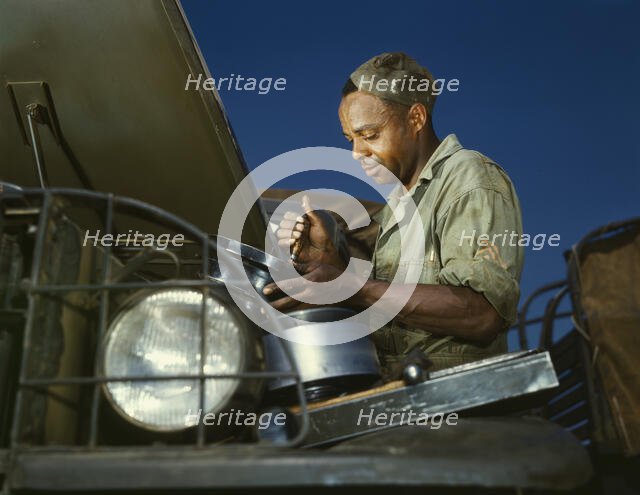 A good job in the air cleaner of an army truck, Fort Knox, Ky., 1942. Creator: Alfred T Palmer.