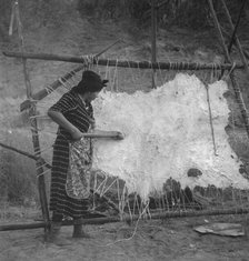 Method of scraping hide for softening, Indian fishing village, Oregon, 1939. Creator: Dorothea Lange.