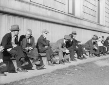 Unemployed men sitting on the sunny side of the San Francisco Public Library, California, 1937. Creator: Dorothea Lange.