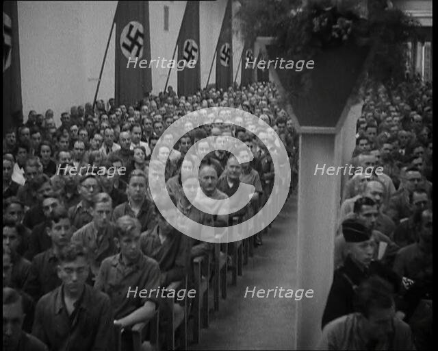People Watching an  Orchestra with Nazi Flags on the Walls, 1937. Creator: British Pathe Ltd.