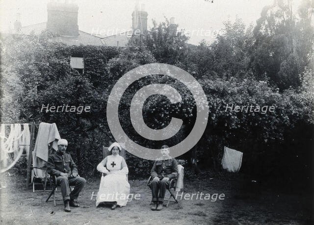 Holmleigh Auxiliary Military Hospital, Harrow: a nurse and two soldiers, one of whom has..., c1922. Creator: Unknown.