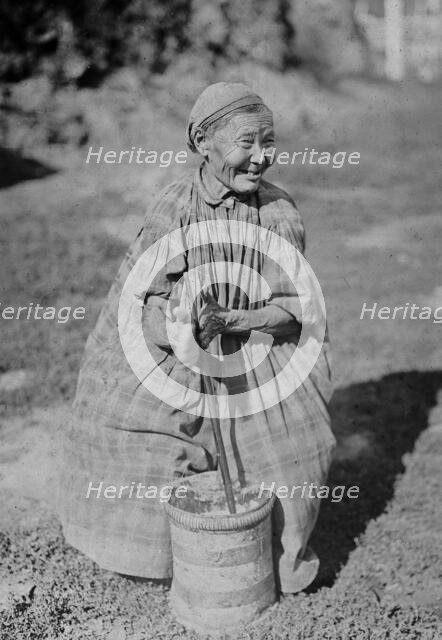 Butter churning, 1890. Creator: Unknown.