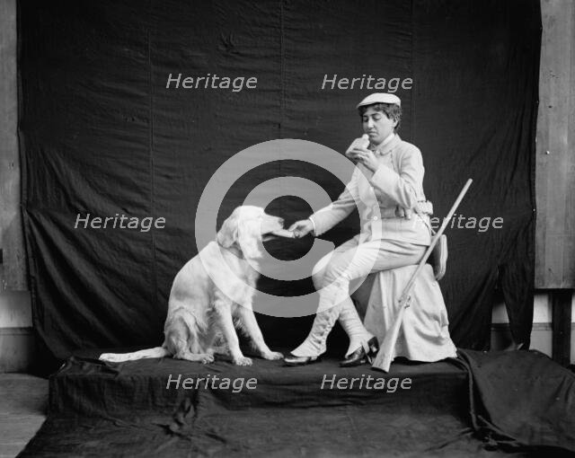 Billy and his mistress in hunting poses, between 1895 and 1910. Creator: Unknown.
