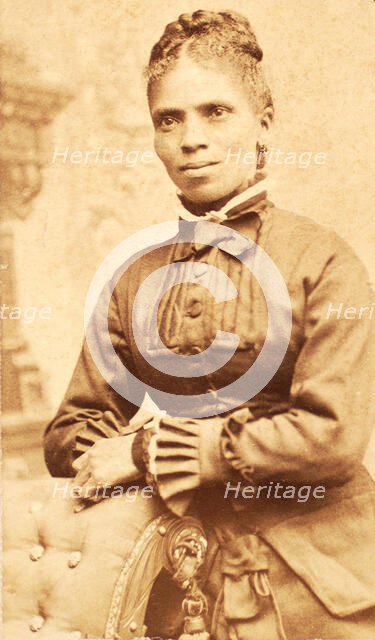 Studio portrait of unidentified woman, arms on back of chair, c1880-c1889. Creator: Richmond Photograph Co.