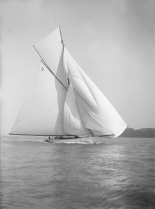 The cutter 'Rosamond' sailing with spinnaker, 1911. Creator: Kirk & Sons of Cowes.