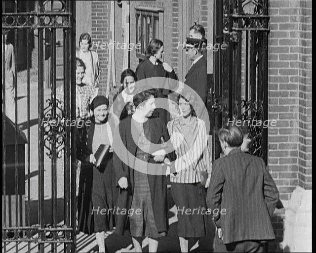 Workers Leaving Factory Through Factory Gates Which Are Closed After Them, 1932. Creator: British Pathe Ltd.