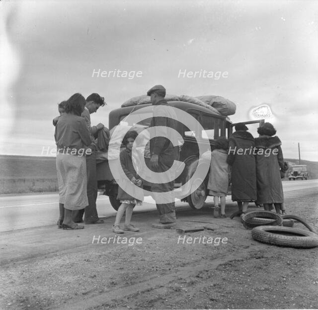 Migrants, family of Mexicans, on road with tire trouble, looking for work...California, 1936. Creator: Dorothea Lange.