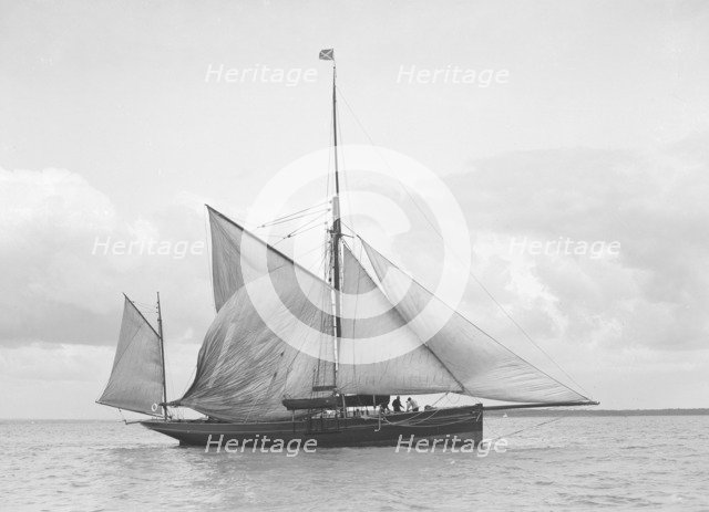The yawl 'Roma' raising main sail, 1912. Creator: Kirk & Sons of Cowes.