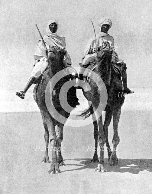 Two Arabs riding camels in the Sahara Desert, Africa, 1936.Artist: Fox Photos