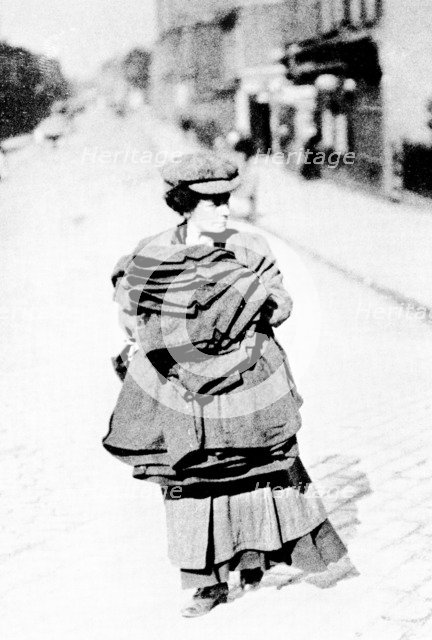 Woman carrying sacks, London, c1900. Artist: Unknown