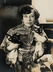 Tilla Durieux with two Siamese cats, 1920s. Creator: Stone, Sasha (1895-1940).