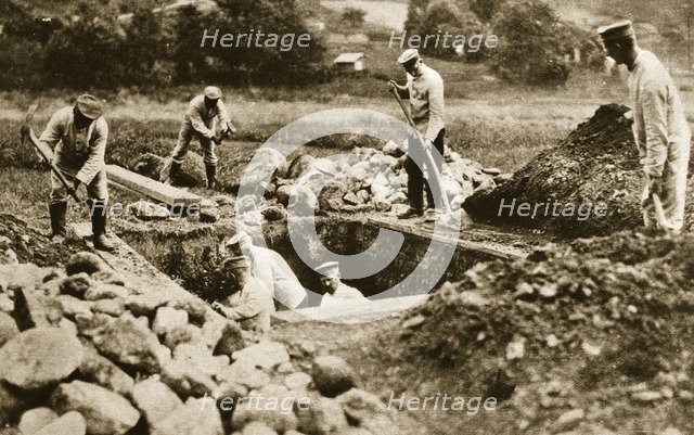 Digging mass graves behind the German lines, World War I, c1914-c1918. Artist: Unknown