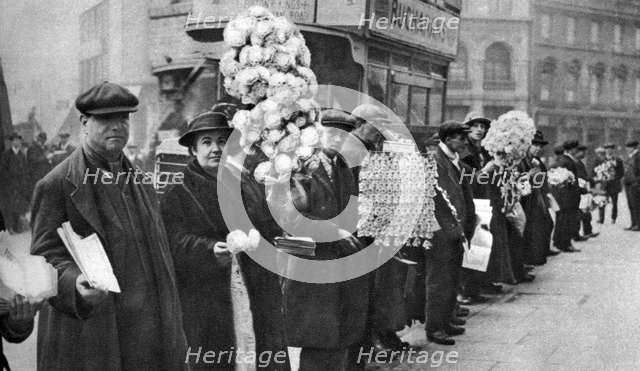 Street hawkers selling football favours in Walham Green, London, 1926-1927. Artist: Unknown